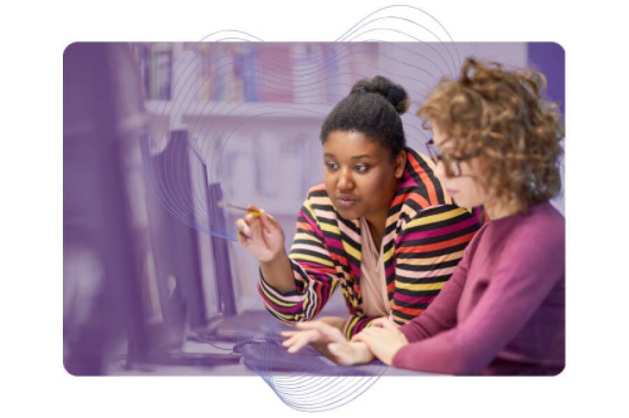 Student and teacher using a computer